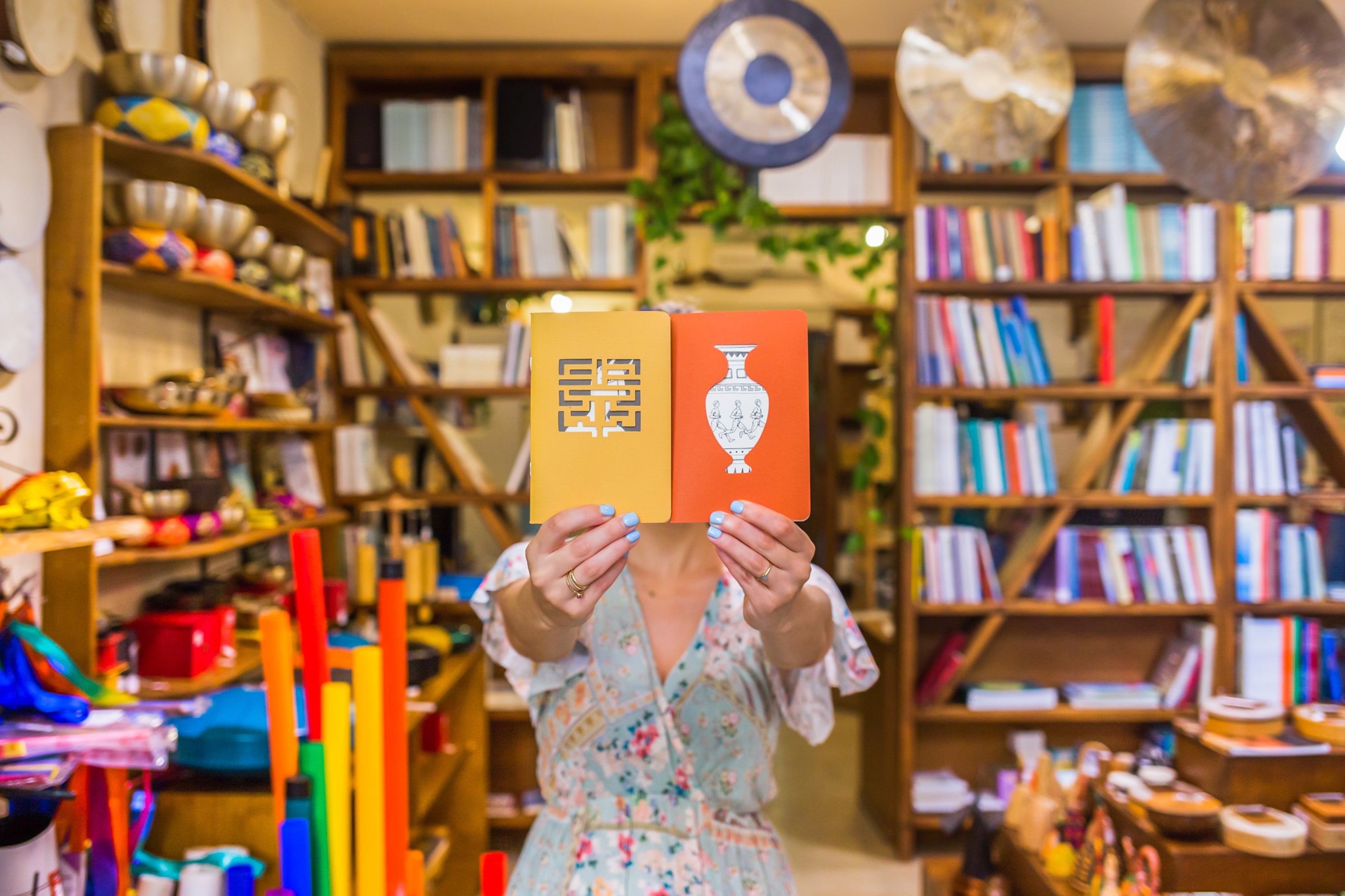 In Fagottobooks store. A woman shows us a MyThink postcard